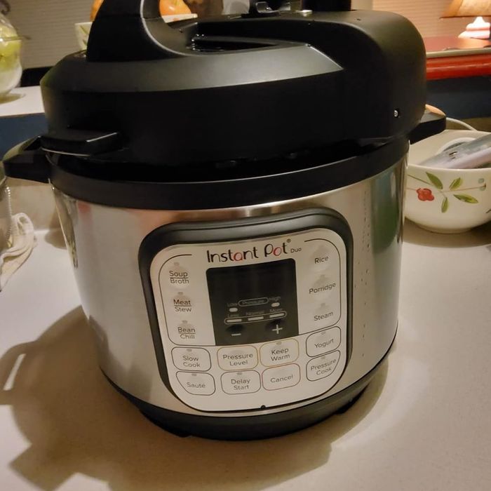An Instant Pot Duo sitting on a kitchen counter, highlighting its control panel and diverse cooking options