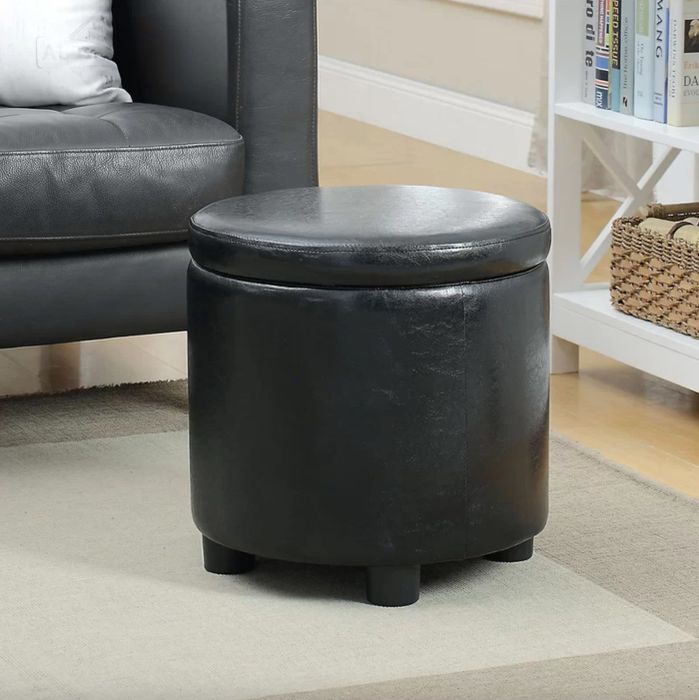This sleek black leather storage ottoman is the perfect addition to any room, offering both functionality and style.