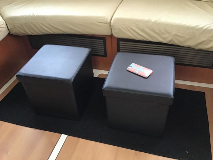 A photo of two black Songmics storage ottomans.