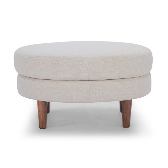 An oval ottoman with smooth, rounded edges and wooden legs, ideal for infusing a cozy and welcoming vibe into your living room.