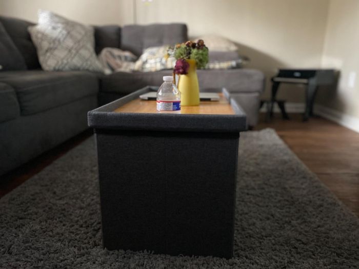 A photo review of a rectangular ottoman serving as a coffee table.