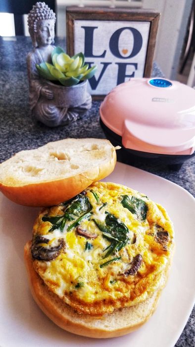 A breakfast sandwich featuring an egg, cooked right inside the mini maker.