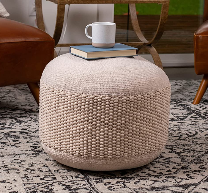 An image featuring a soft light pink ottoman.