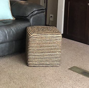 A reviewer’s image featuring a square pouf ottoman.