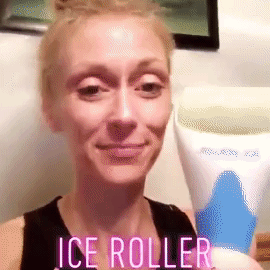 A reviewer applying the ice roller to their face
