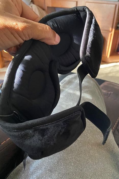 Another reviewer holding the mask, showcasing the contoured eye padding