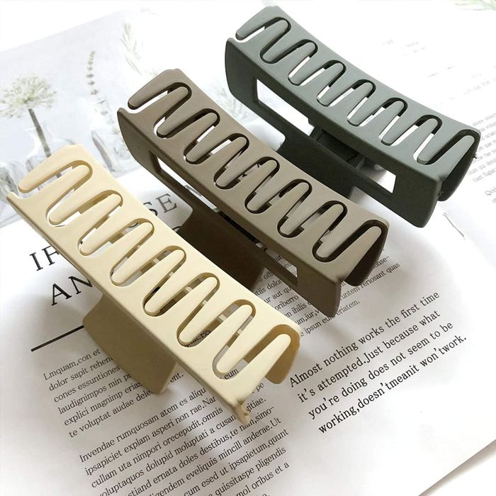 A set of three claw clips in matte shades of beige, green, and teal