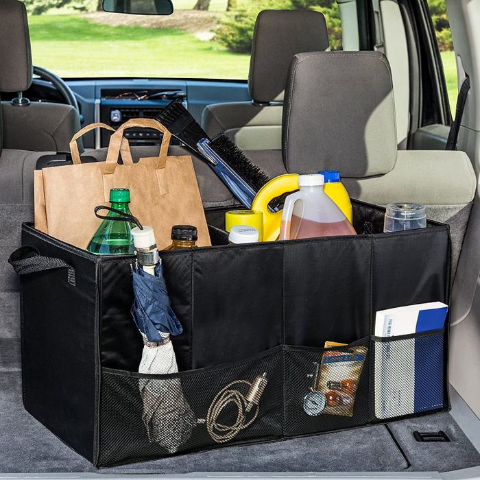 A bin with pockets on the outside and handles for easy carrying