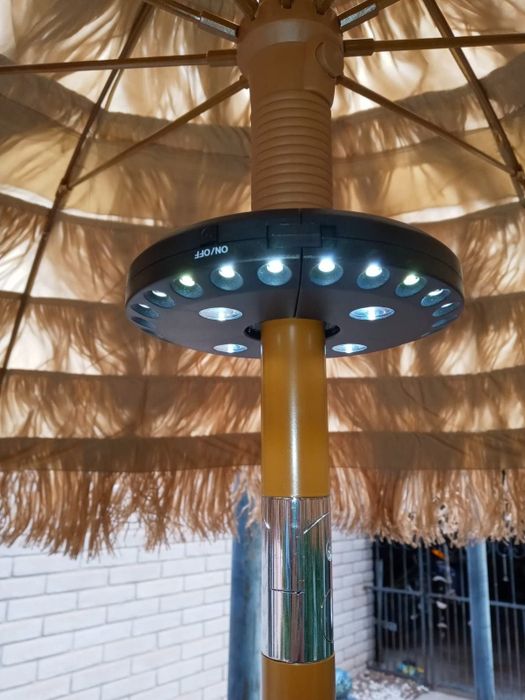 a reviewer's photo showing a clip-on umbrella light in use