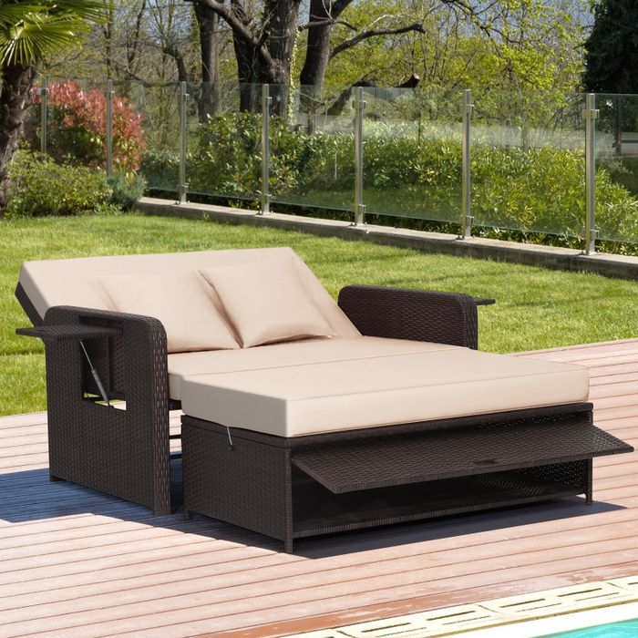 The beige daybed fully extended, with the ottoman positioned as a footrest for extra comfort.