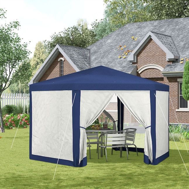 A gazebo with open flaps, set up in a backyard next to a house. Inside, a dining table and chairs are arranged. Trees and a fence are visible in the background.