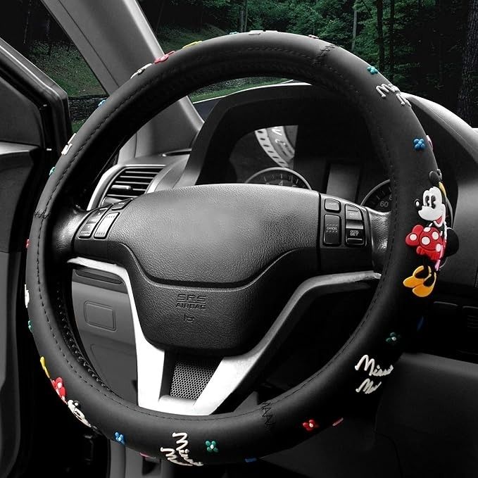 A Minnie Mouse-themed steering wheel cover with embroidered details, placed on a parked car’s steering wheel