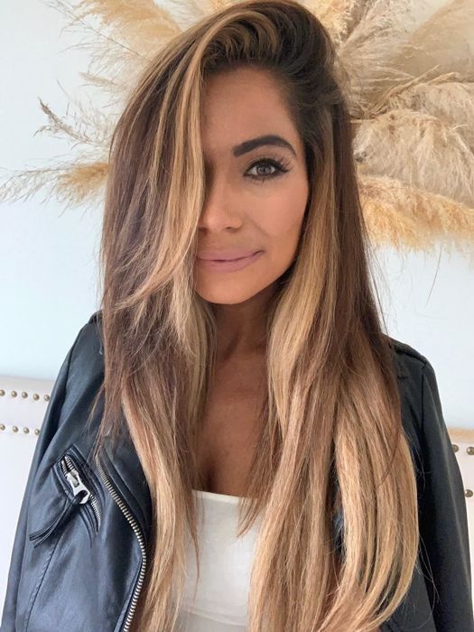 A reviewer showing long, voluminous hair after using the product.