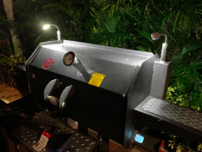 A picture of the lights illuminating a closed grill, providing a bright and clear view of the surrounding area.