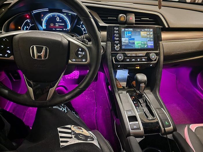 A reviewer's car illuminated with purple interior LED lights