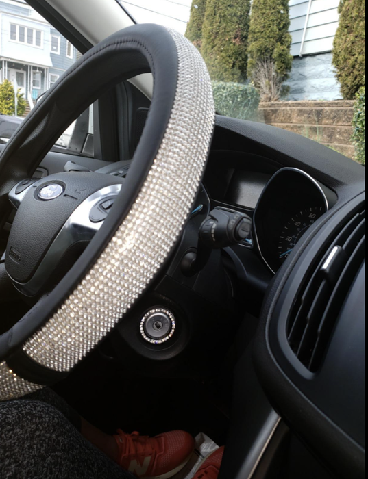 A reviewer photo showing the blinged-out steering wheel cover