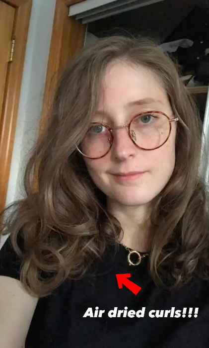 Me with voluminous, loose curls and the caption 'air-dried curls'.