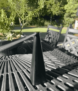 A sleek black outdoor fan, designed to face upward, circulating air.