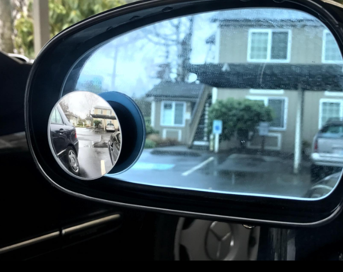 A review photo showing the blind spot mirror attached to a car side mirror