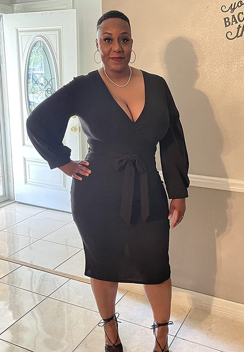 Reviewer in a black midi dress.