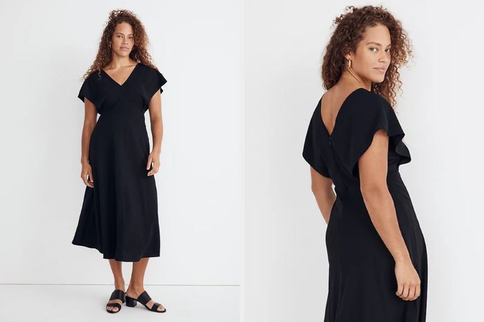 A model wearing a black midi dress with a V-neckline and flutter sleeves, paired with black open-toed sandals. The back view of the model showcases the dress against a gray backdrop.