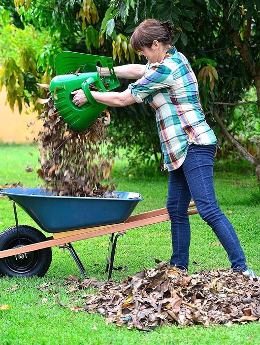 a person using large scooping claws to move leaves