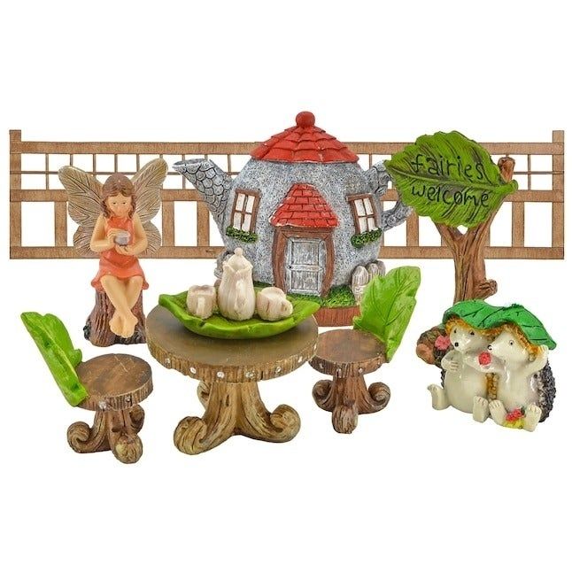 each item in the fairy garden kit, such as a teapot cottage and lattice fences
