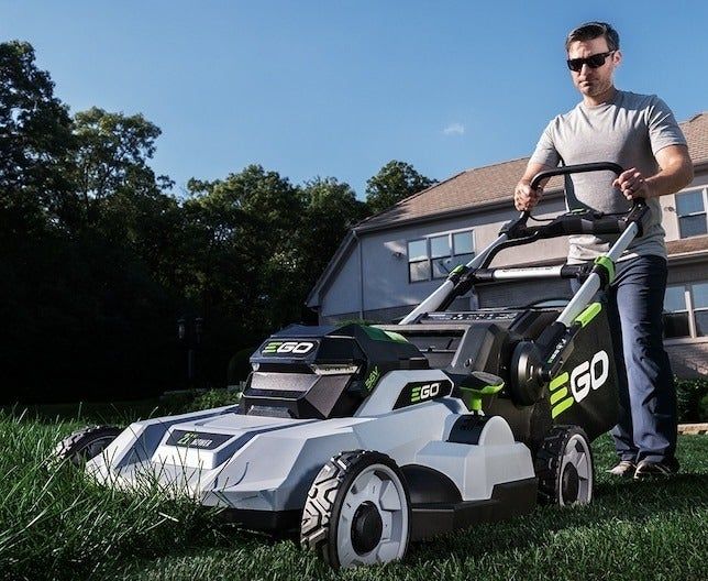a person demonstrating the use of the lawn mower
