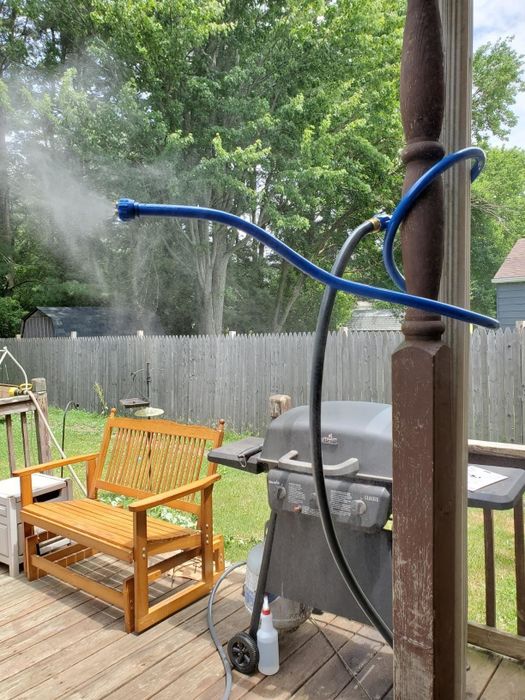A reviewer photo showing a blue mister attachment wrapped around a pole
