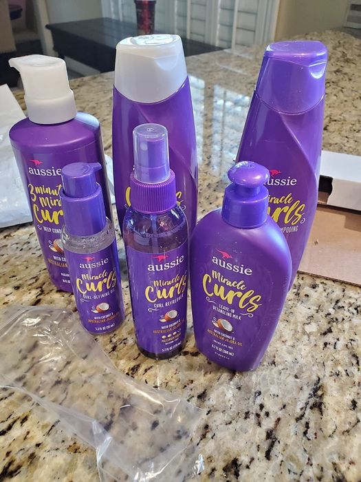 Reviewer's photo showcasing the Aussie Miracle Curls product set