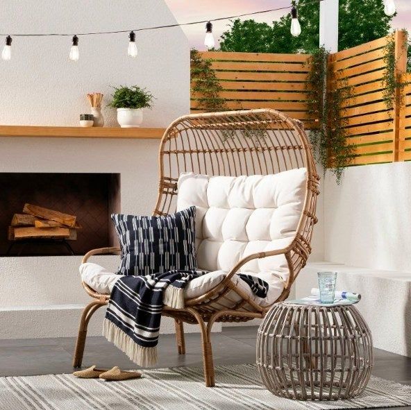 The chair adorned with a pillow and blanket