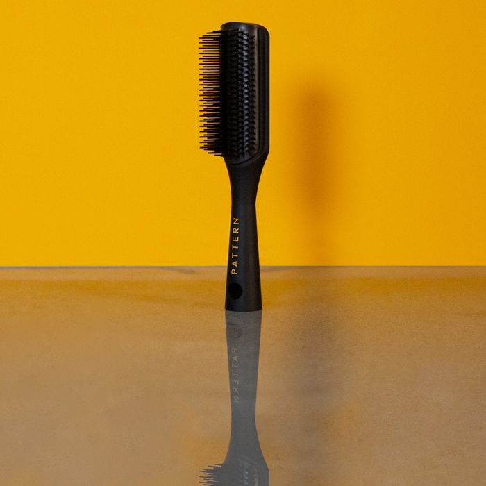 Product image of the shower brush set against a vibrant yellow background