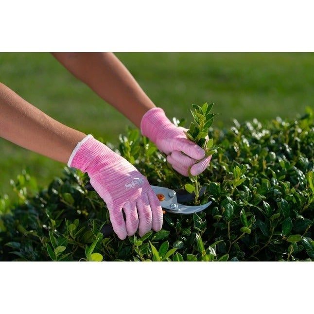 A person wearing the gloves while gardening