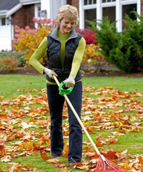 A person demonstrating how to rake with a tool attachment on their rake.
