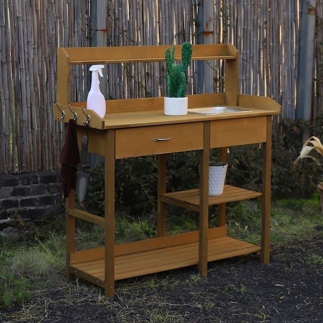 the wooden potting bench with shelves for garden use