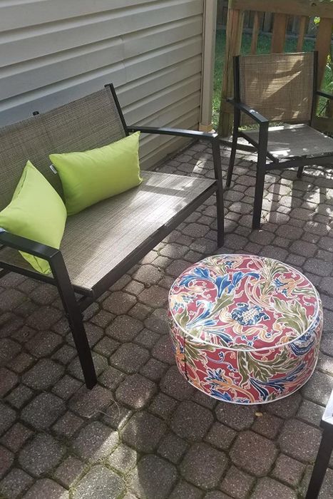 A photo from a reviewer showing a patio chair with a printed ottoman placed in front of it