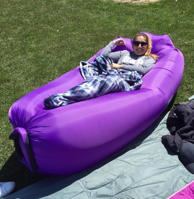 A reviewer lounging in a purple inflatable chair