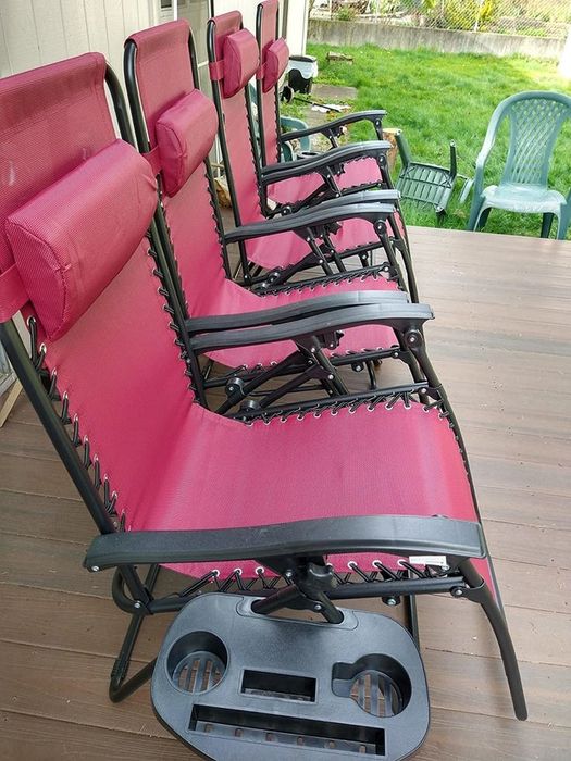Four of the lounge chairs with one featuring an attached cup holder