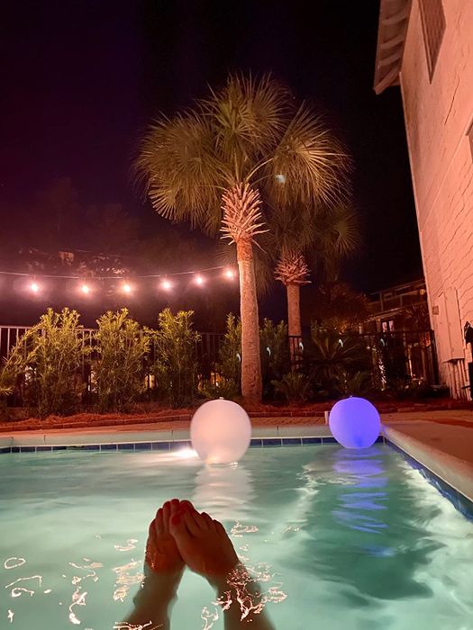 A pool with two floating balls gently drifting on its surface, as seen by the reviewer.