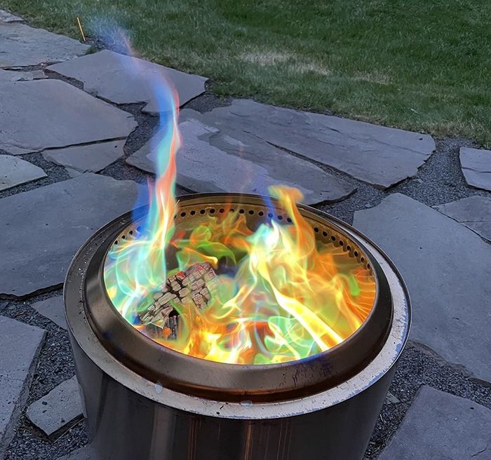 A photo of the fire pit with mesmerizing blue, orange, and green flames