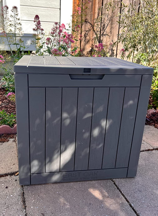 A reviewer's photo of a square storage box placed outdoors.