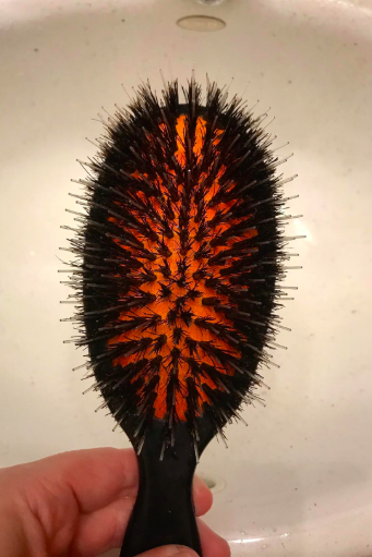 The same hairbrush, now clean, revealing the base clearly.