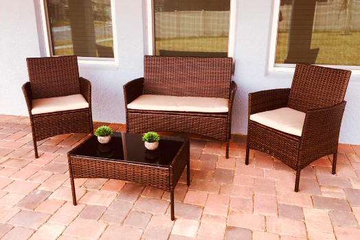 A reviewer's brown chairs and table set up outdoors