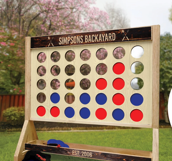 The giant Connect 4 game featuring both blue and red discs, ready for an exciting challenge.