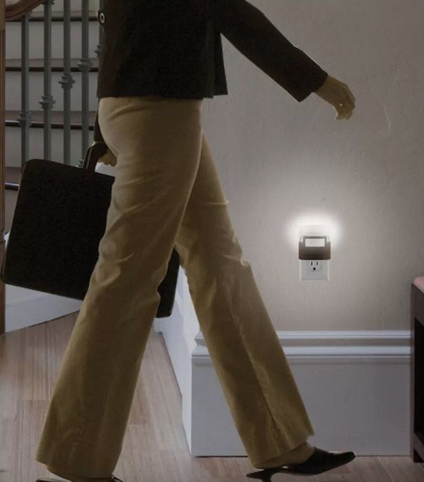 A model walking by a motion-activated night light in a hallway