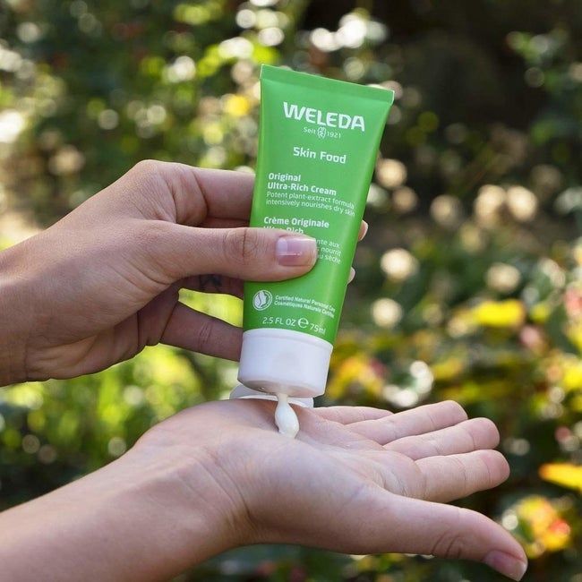 A person squeezing some of the product into their open palm.