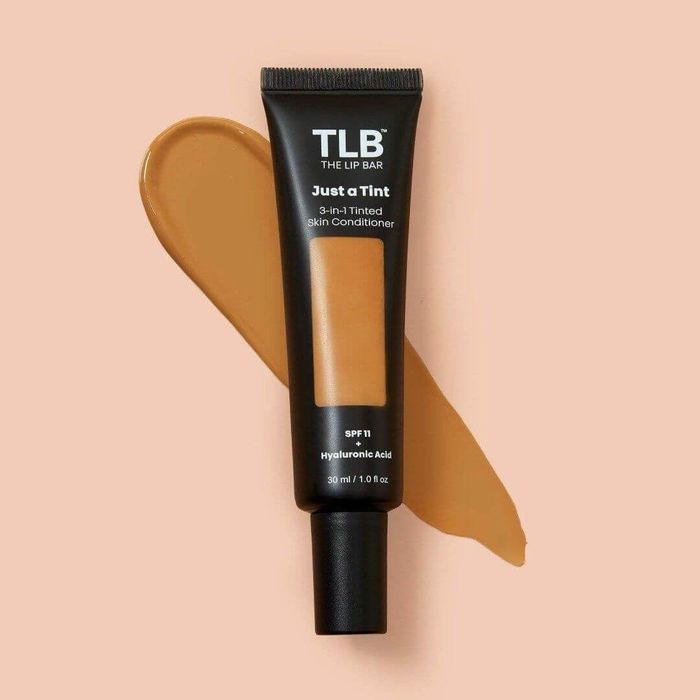 A squeeze bottle of the product in the shade Caramel Delight.