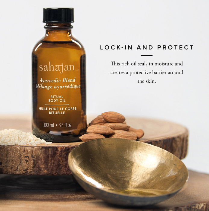 A bottle of oil placed on a wooden platform, accompanied by a pile of almonds beside it.