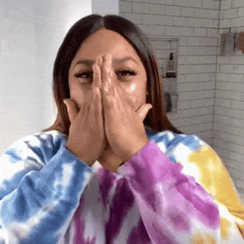 A GIF of a reviewer gently massaging moisturizer into their skin