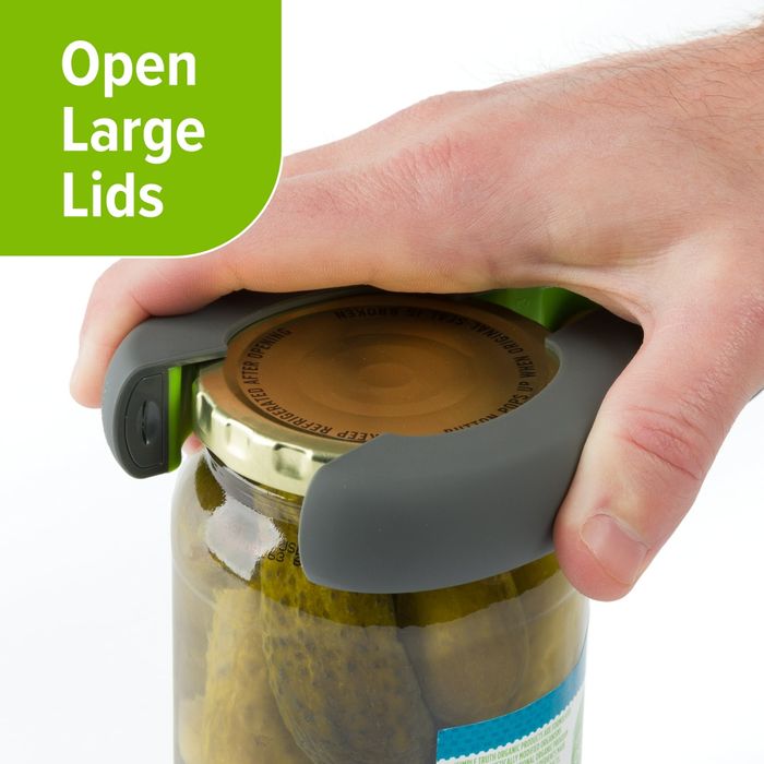 A hand is shown using a lid opener tool to effortlessly open a jar of pickles, accompanied by the text 'Open Large Lids.'